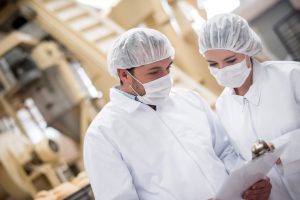 Quality assurance technicians in food processing plant